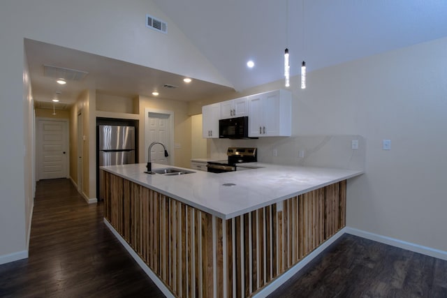 3127 Mcdermott Ave, Dallas, TX 75215 - kitchen with stainless steel appliances, dark wood finished floors, lofted ceiling, white cabinets, and a peninsula