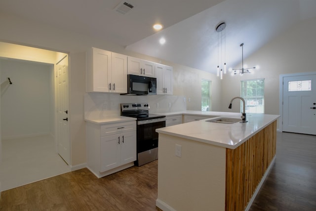 3127 Mcdermott Ave, Dallas, TX 75215 - kitchen featuring stainless steel electric stove, black microwave, dark wood-type flooring, vaulted ceiling, and white cabinets