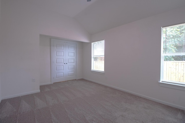 3127 Mcdermott Ave, Dallas, TX 75215 - empty room featuring healthy amount of natural light, light colored carpet, and vaulted ceiling