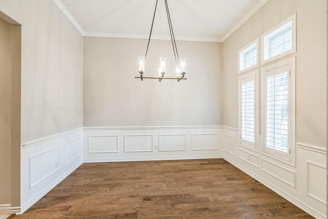 4471 Chandler Dr, Frisco, TX 75034 - unfurnished dining area featuring a chandelier, crown molding, a decorative wall, dark wood-style flooring, and wainscoting