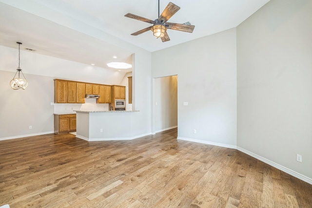 4471 Chandler Dr, Frisco, TX 75034 - unfurnished living room featuring ceiling fan, light wood-style flooring, and high vaulted ceiling