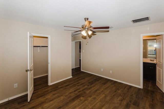 724 Autumnwood Way, Princeton, TX 75407 - unfurnished bedroom featuring dark wood-type flooring, a closet, a walk in closet, and a ceiling fan
