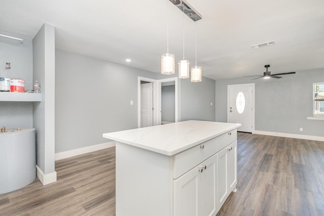3828 Pacesetter Dr, Dallas, TX 75241 - kitchen with a center island, light wood finished floors, ceiling fan, white cabinetry, and recessed lighting