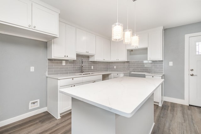 3828 Pacesetter Dr, Dallas, TX 75241 - kitchen featuring decorative backsplash, dark wood finished floors, white cabinetry, and a kitchen island