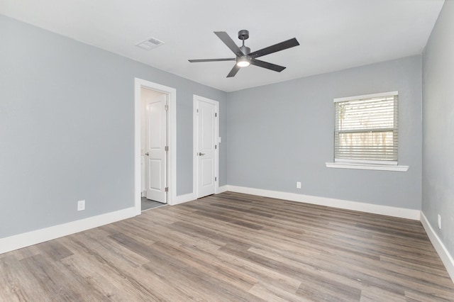 3828 Pacesetter Dr, Dallas, TX 75241 - unfurnished bedroom with wood finished floors and a ceiling fan