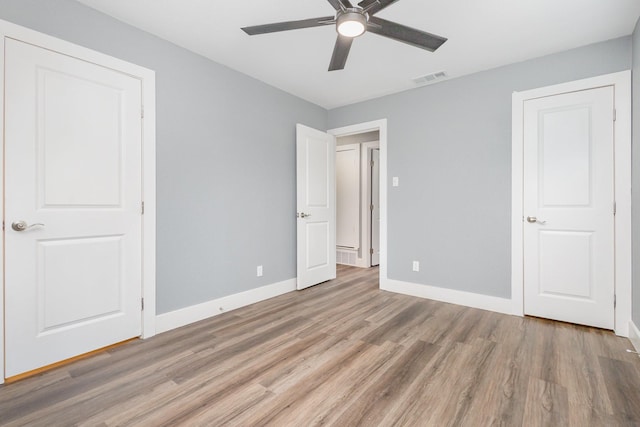 3828 Pacesetter Dr, Dallas, TX 75241 - unfurnished bedroom with light wood finished floors and ceiling fan