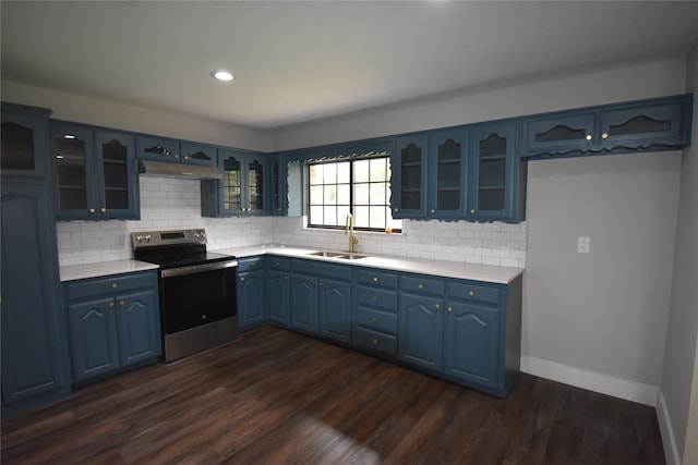 4918 Stagecoach Ln, Garland, TX 75043 - kitchen with stainless steel electric stove, blue cabinetry, light countertops, backsplash, and glass insert cabinets