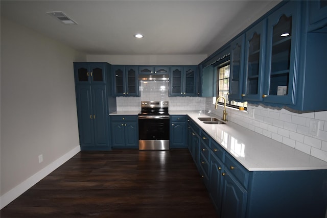 4918 Stagecoach Ln, Garland, TX 75043 - kitchen with stainless steel range with electric stovetop, blue cabinetry, dark wood-type flooring, decorative backsplash, and light countertops