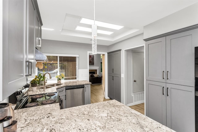 14902 Le Grande Dr, Addison, TX 75001 - kitchen featuring stainless steel dishwasher, range with electric stovetop, gray cabinetry, light stone countertops, and light wood-style flooring