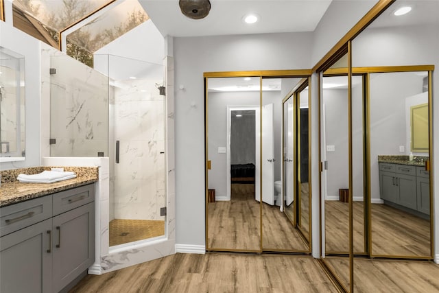 14902 Le Grande Dr, Addison, TX 75001 - full bath featuring a marble finish shower, wood finished floors, vanity, and recessed lighting