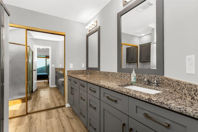 14902 Le Grande Dr, Addison, TX 75001 - ensuite bathroom with double vanity and wood finished floors