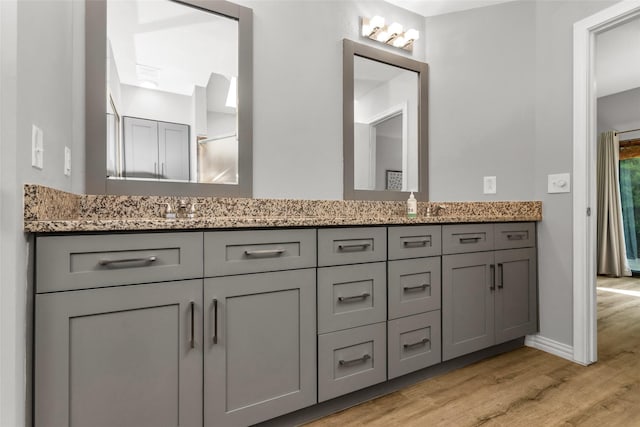 14902 Le Grande Dr, Addison, TX 75001 - bathroom featuring double vanity and wood finished floors