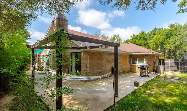 14902 Le Grande Dr, Addison, TX 75001 - rear view of property with a patio area, a chimney, brick siding, and roof with shingles