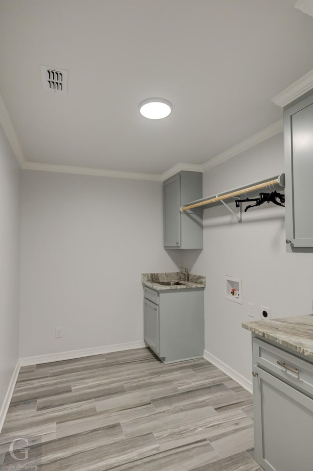 163 Sistrunk Ln, Bossier City, LA 71112 - washroom with hookup for an electric dryer, hookup for a washing machine, crown molding, and light wood-style flooring