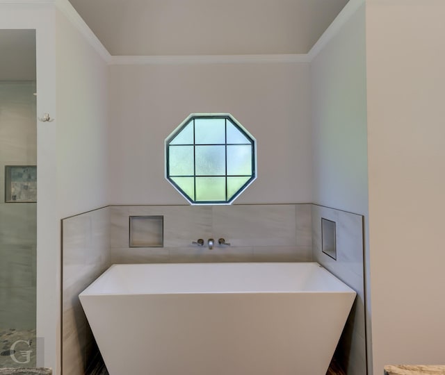 163 Sistrunk Ln, Bossier City, LA 71112 - bathroom with ornamental molding, a freestanding bath, and tile walls