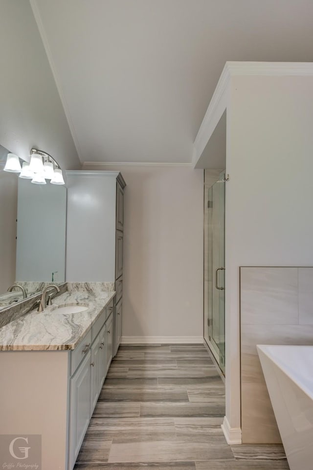 163 Sistrunk Ln, Bossier City, LA 71112 - full bathroom with a freestanding tub, double vanity, a shower stall, wood finished floors, and crown molding