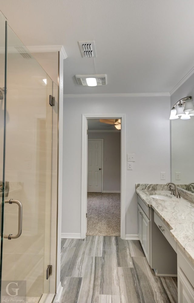163 Sistrunk Ln, Bossier City, LA 71112 - bathroom with ornamental molding, vanity, wood finished floors, a stall shower, and ceiling fan