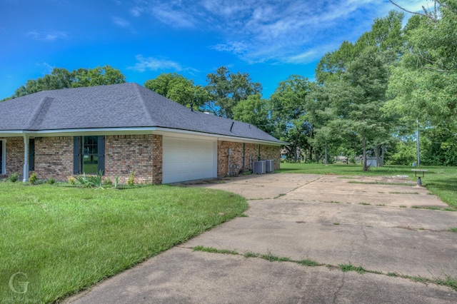 163 Sistrunk Ln, Bossier City, LA 71112 - view of home's exterior featuring a garage, a yard, brick siding, and concrete driveway