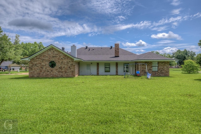 163 Sistrunk Ln, Bossier City, LA 71112 - back of house with a chimney, a yard, and brick siding