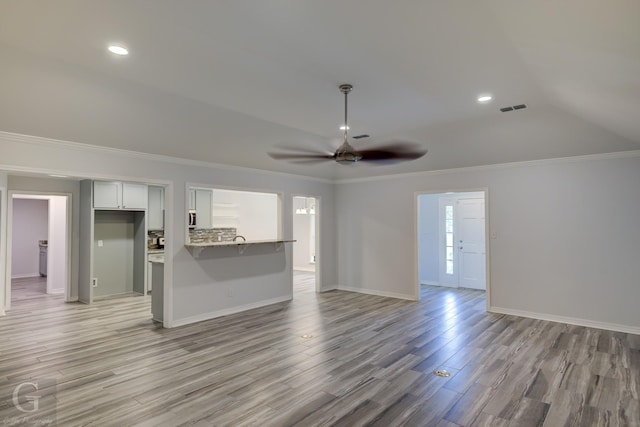 163 Sistrunk Ln, Bossier City, LA 71112 - unfurnished living room featuring ceiling fan, light wood-style flooring, recessed lighting, crown molding, and vaulted ceiling