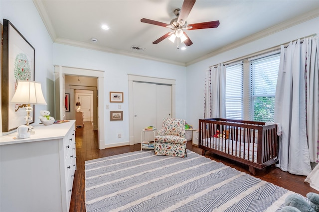 5818 Worth St, Dallas, TX 75214 - bedroom featuring dark wood-style flooring, ornamental molding, a closet, a nursery area, and ceiling fan