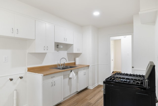 1308 Edgecliff Rd, Fort Worth, TX 76134 - kitchen with gas stove, white cabinetry, and light wood finished floors