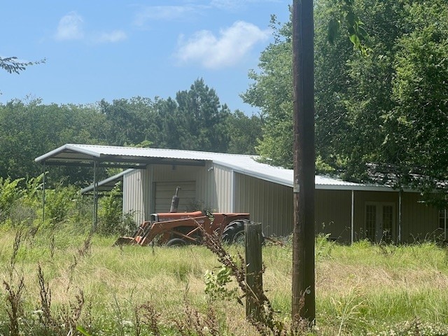 1170 County Road 34020, Brookston, TX 75421 - view of pole building with french doors and a view of trees