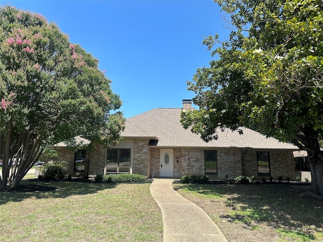 1112 Ranger Ct, Plano, TX 75075 - view of front of home with brick siding, a front yard, a chimney, and a shingled roof