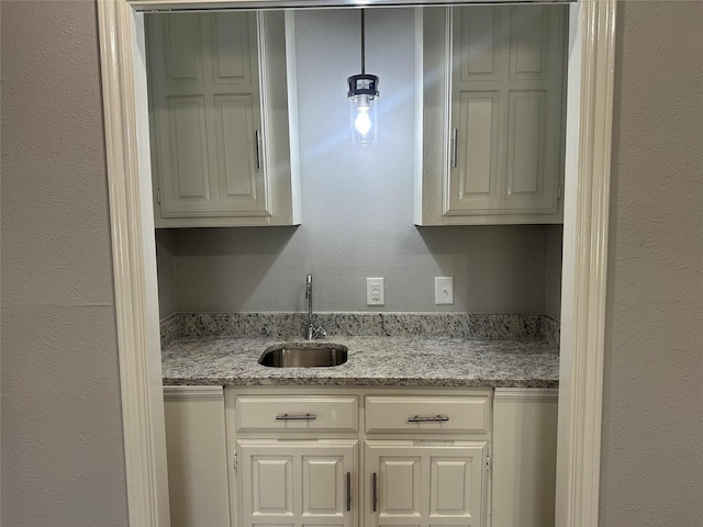 1112 Ranger Ct, Plano, TX 75075 - kitchen featuring light stone counters and white cabinets