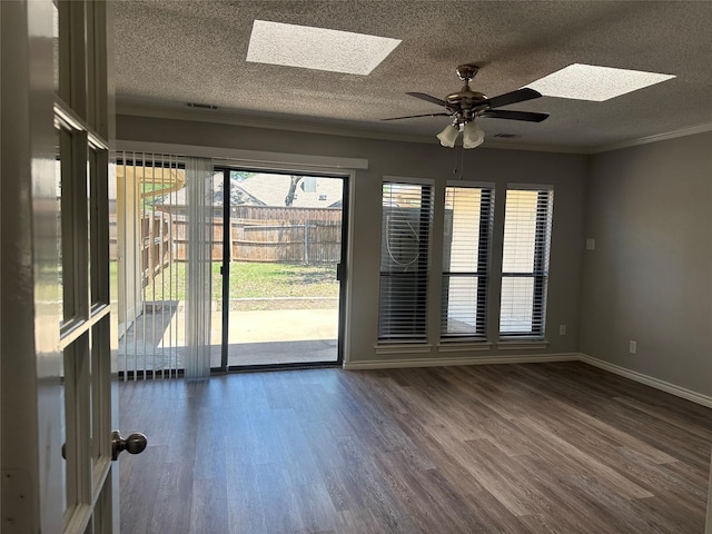 1112 Ranger Ct, Plano, TX 75075 - spare room with a skylight, dark wood finished floors, plenty of natural light, a ceiling fan, and ornamental molding