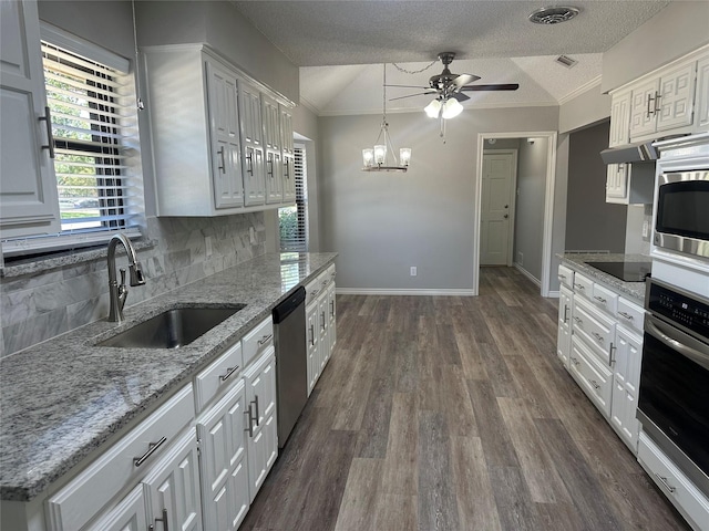 1112 Ranger Ct, Plano, TX 75075 - kitchen featuring appliances with stainless steel finishes, tasteful backsplash, a ceiling fan, white cabinetry, and dark wood-style floors