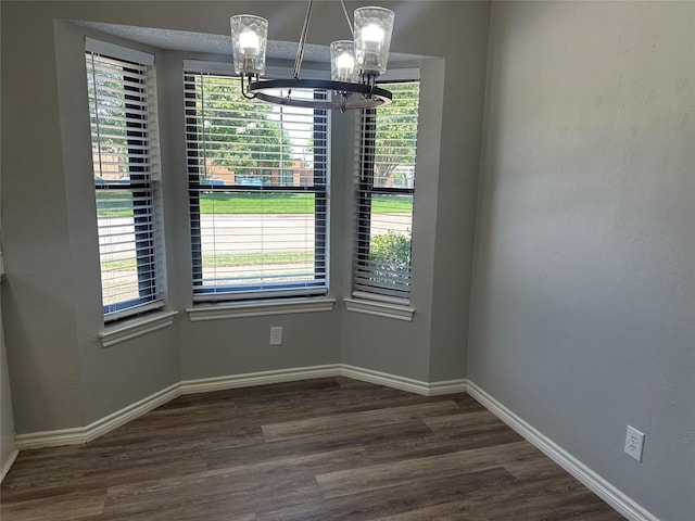 1112 Ranger Ct, Plano, TX 75075 - unfurnished dining area featuring a chandelier and dark wood-style flooring