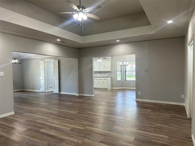 1112 Ranger Ct, Plano, TX 75075 - spare room featuring ceiling fan, dark wood-style floors, a raised ceiling, recessed lighting, and a high ceiling
