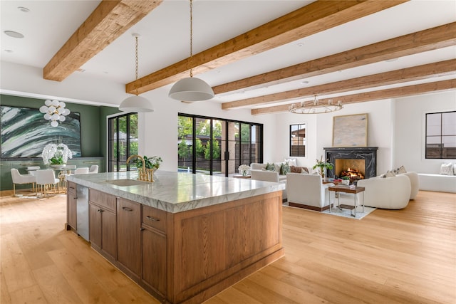 7226 Colgate Ave, Dallas, TX 75225 - kitchen featuring light wood-style flooring, open floor plan, pendant lighting, and beamed ceiling