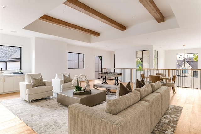 7226 Colgate Ave, Dallas, TX 75225 - living area featuring light wood-style flooring, a chandelier, and beam ceiling