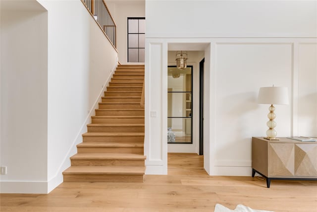 7226 Colgate Ave, Dallas, TX 75225 - staircase featuring baseboards and wood finished floors
