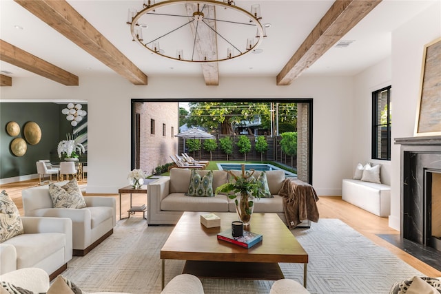 7226 Colgate Ave, Dallas, TX 75225 - living area with beam ceiling, light wood finished floors, and a chandelier