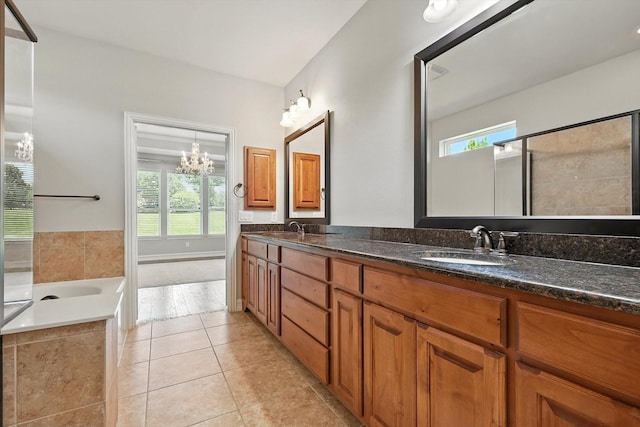 6460 Cherry Hills Dr, Frisco, TX 75036 - bathroom featuring double vanity, a bath, plenty of natural light, and a chandelier
