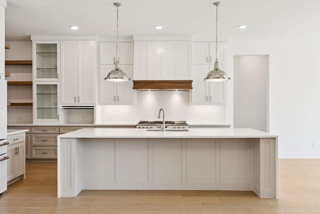 4541 Walnut Grove Ln, Prosper, TX 75078 - kitchen featuring light countertops, an island with sink, light wood finished floors, decorative light fixtures, and recessed lighting