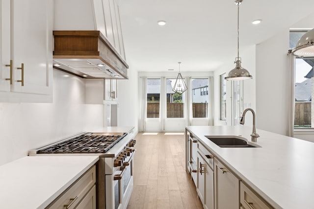 4541 Walnut Grove Ln, Prosper, TX 75078 - kitchen with double oven range, light wood-style floors, decorative light fixtures, white cabinets, and recessed lighting
