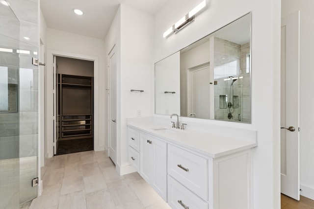 4541 Walnut Grove Ln, Prosper, TX 75078 - bathroom featuring a stall shower, vanity, a spacious closet, and recessed lighting