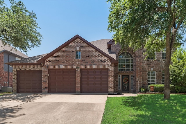 2621 Princeton Dr, Flower Mound, TX 75022 - traditional-style house with a garage, brick siding, driveway, and a front lawn