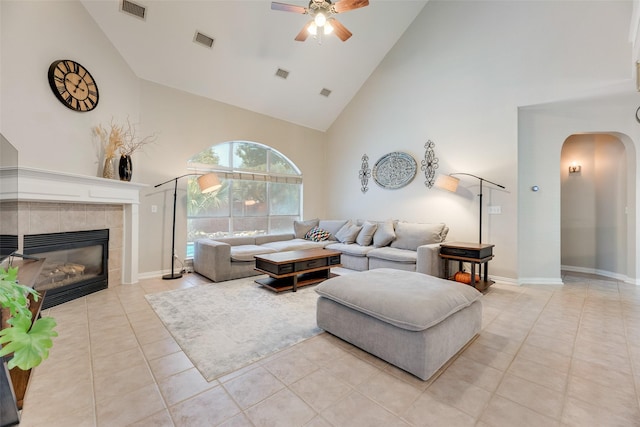 2621 Princeton Dr, Flower Mound, TX 75022 - living area featuring high vaulted ceiling, arched walkways, a ceiling fan, light tile patterned floors, and a fireplace