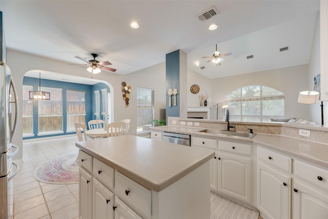 2621 Princeton Dr, Flower Mound, TX 75022 - kitchen featuring a ceiling fan, arched walkways, appliances with stainless steel finishes, lofted ceiling, and recessed lighting