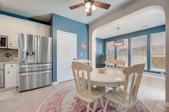 2621 Princeton Dr, Flower Mound, TX 75022 - dining space with arched walkways, a ceiling fan, and light tile patterned flooring
