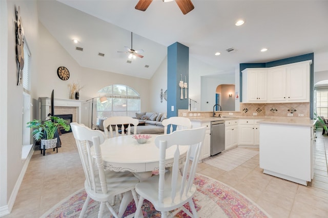 2621 Princeton Dr, Flower Mound, TX 75022 - dining room with ceiling fan, light tile patterned flooring, lofted ceiling, a tiled fireplace, and recessed lighting