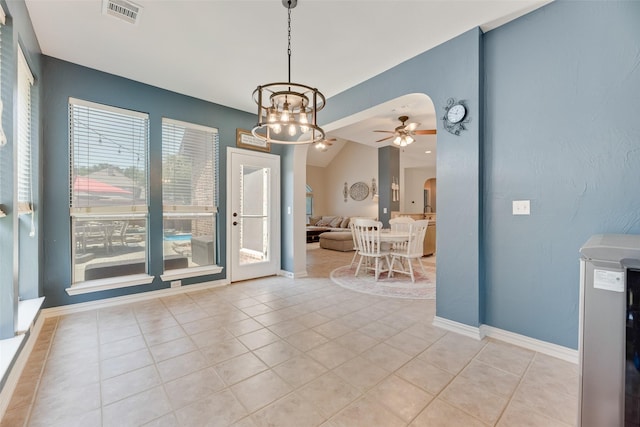 2621 Princeton Dr, Flower Mound, TX 75022 - dining area featuring arched walkways, a chandelier, a ceiling fan, and light tile patterned floors
