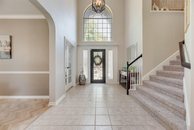 2621 Princeton Dr, Flower Mound, TX 75022 - foyer entrance with stairs, arched walkways, a high ceiling, and ornamental molding