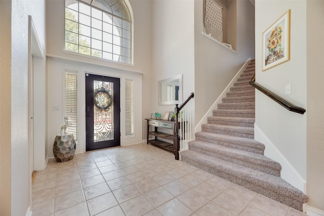2621 Princeton Dr, Flower Mound, TX 75022 - entryway featuring stairway, a high ceiling, and light tile patterned floors