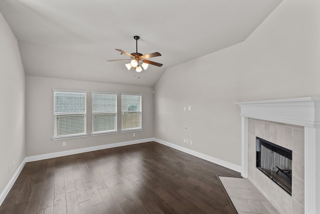 6001 Harwich Ln, Fort Worth, TX 76179 - unfurnished living room with lofted ceiling, ceiling fan, dark wood-style floors, and a tile fireplace